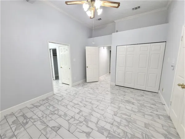 an empty room with kitchen view