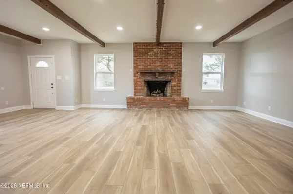 a view of a room with wooden floor and closet