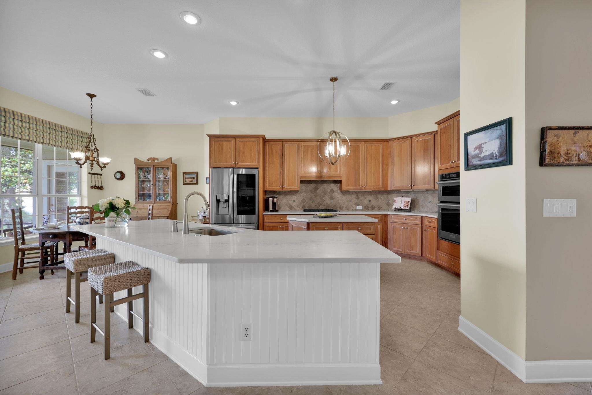 159 La Mesa Drive St. Augustine, FL 32095 - Photo 12 of 85 a kitchen with kitchen island stainless steel appliances a sink a counter top space cabinets and a center island