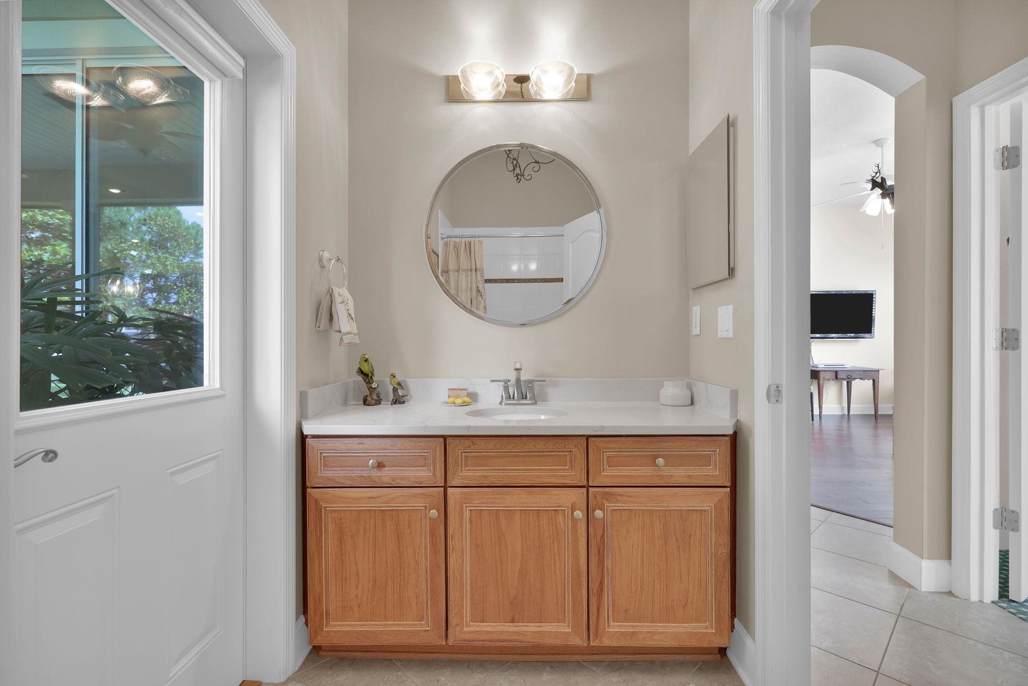 159 La Mesa Drive St. Augustine, FL 32095 - Photo 24 of 85 a bathroom with a sink a mirror and a shower