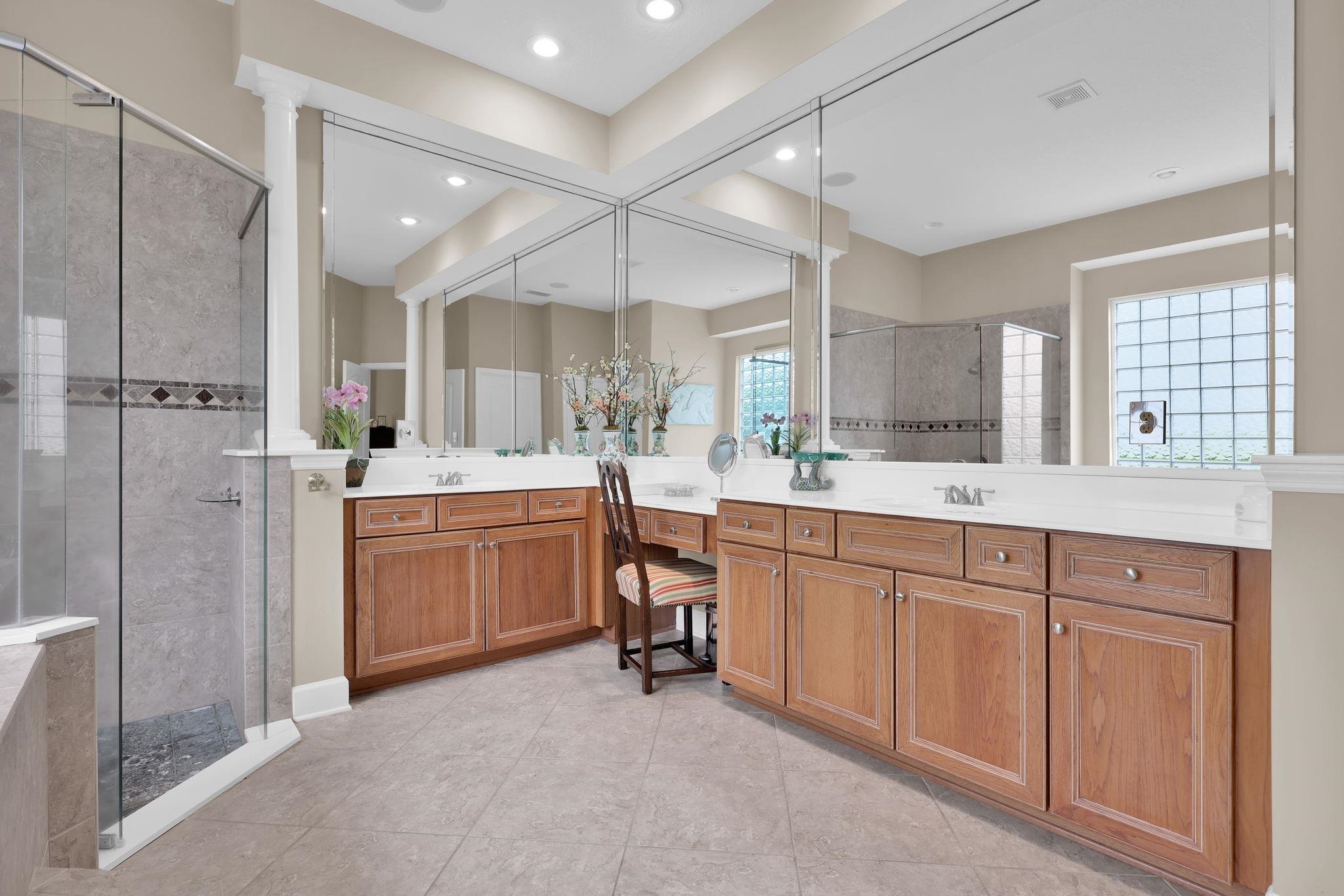 159 La Mesa Drive St. Augustine, FL 32095 - Photo 38 of 85 a large bathroom with a double vanity sink a large mirror and shower