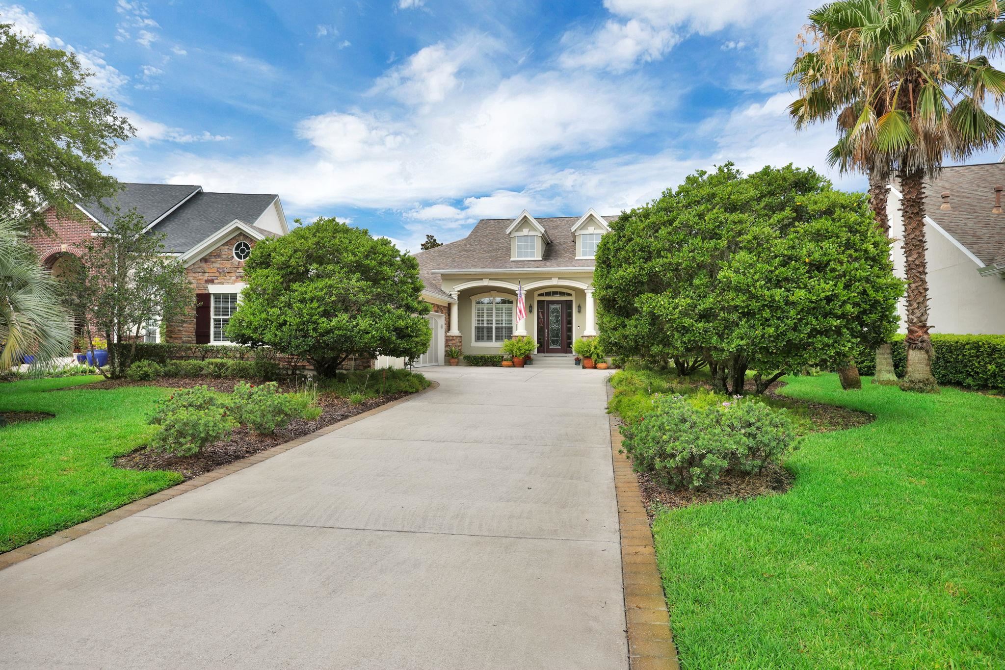 159 La Mesa Drive St. Augustine, FL 32095 - Photo 45 of 85 a front view of a house with a yard and potted plants