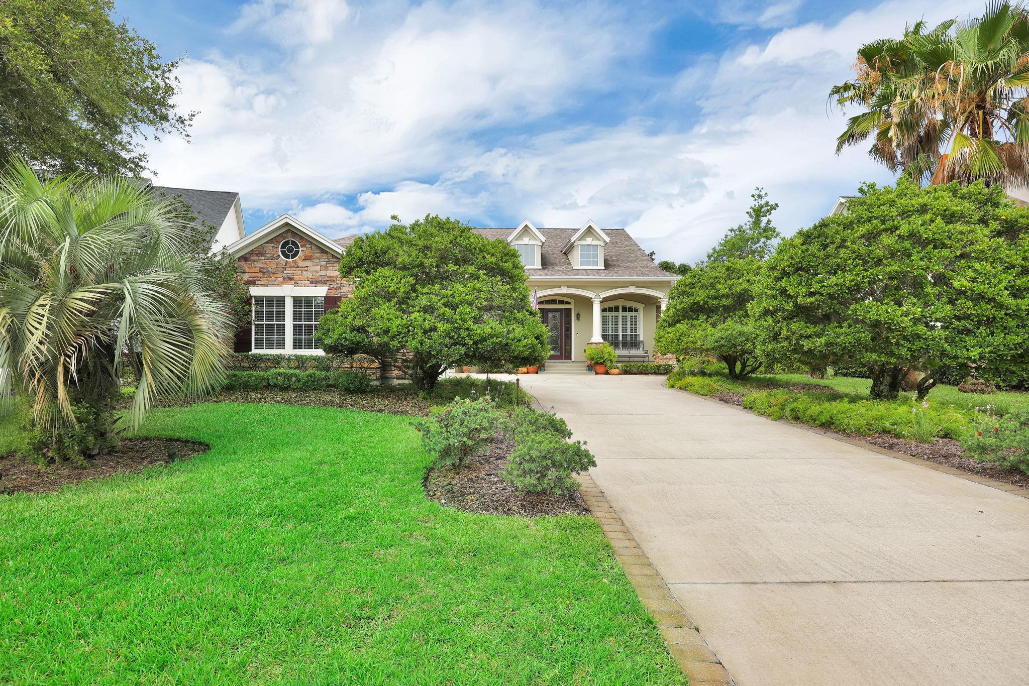 159 La Mesa Drive St. Augustine, FL 32095 - Photo 46 of 85 a front view of a house with a yard and potted plants