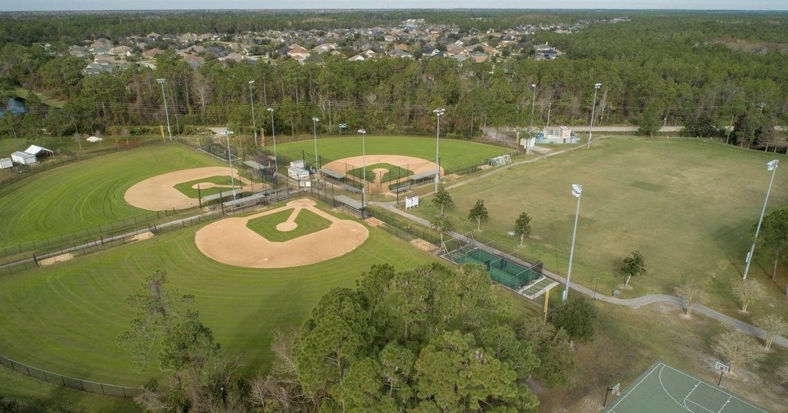 159 La Mesa Drive St. Augustine, FL 32095 - Photo 83 of 85 a backyard of a house with table and chairs