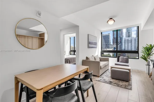 a living room with furniture a mirror and a table