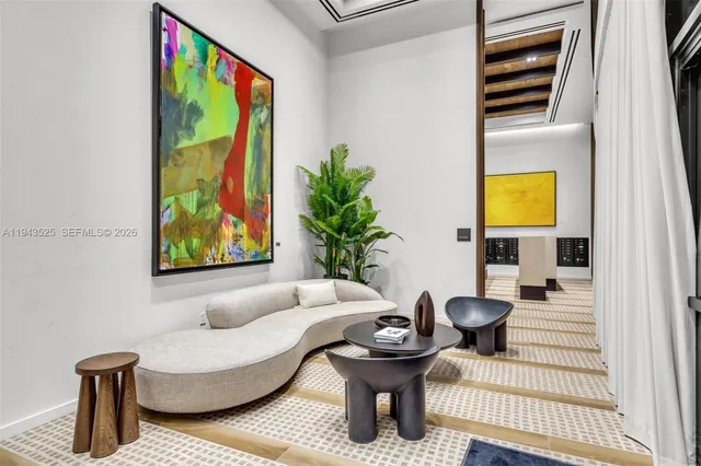 a view of a hallway to a livingroom with wooden floor