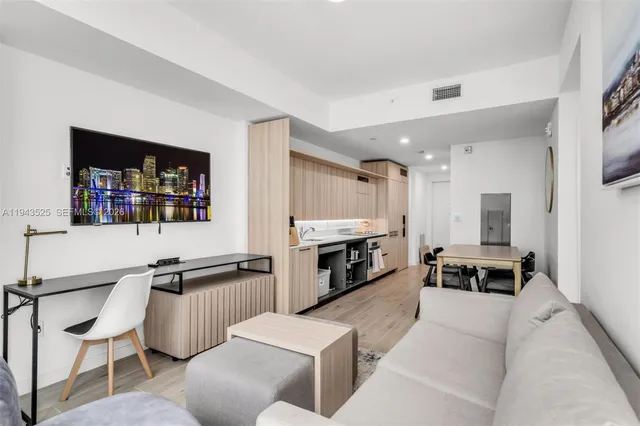 a kitchen with a refrigerator and a stove top oven