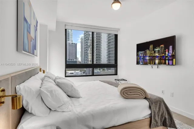 a bedroom with a bed and a wall painting