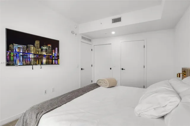 a bedroom with a bed and a book shelf