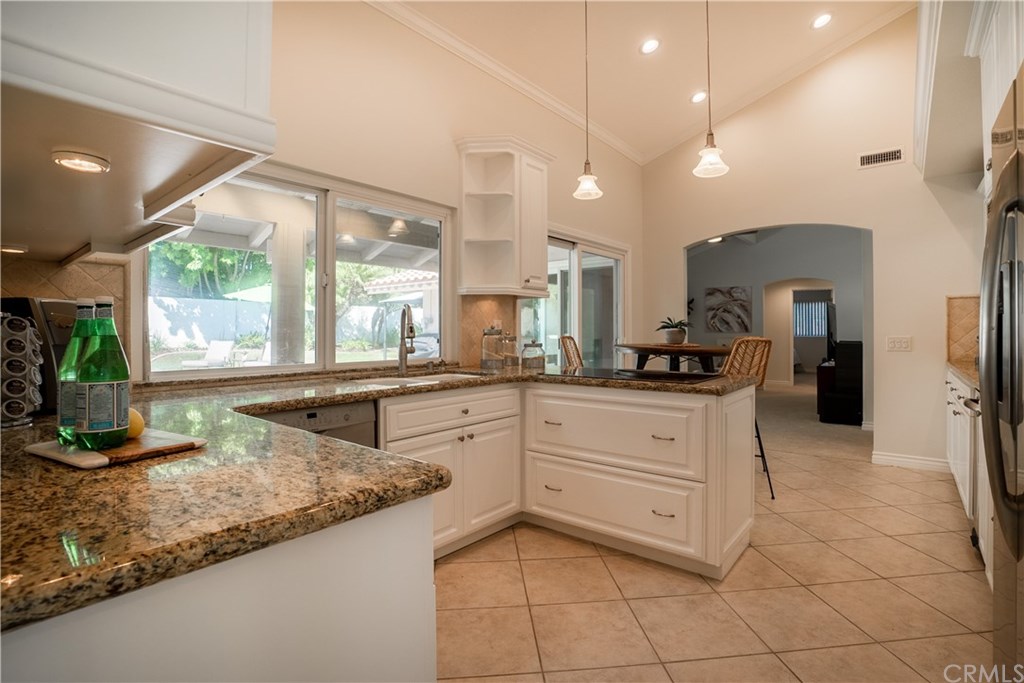 1001 Castlegate Lane North Tustin, CA 92705 - Photo 9 of 30 kitchen opens to family room and has dining area