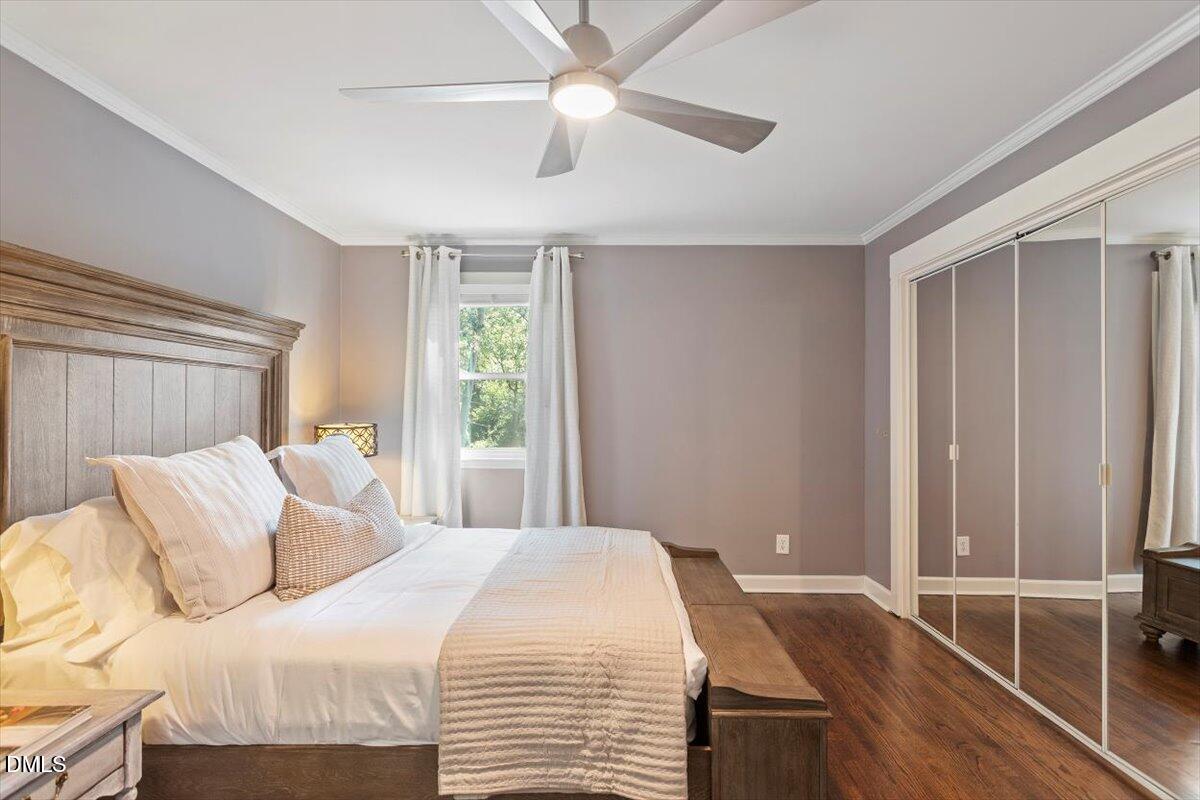2120 Hillock Drive Raleigh, NC 27612 - Photo 24 of 29 a bedroom with a bed and a chandelier