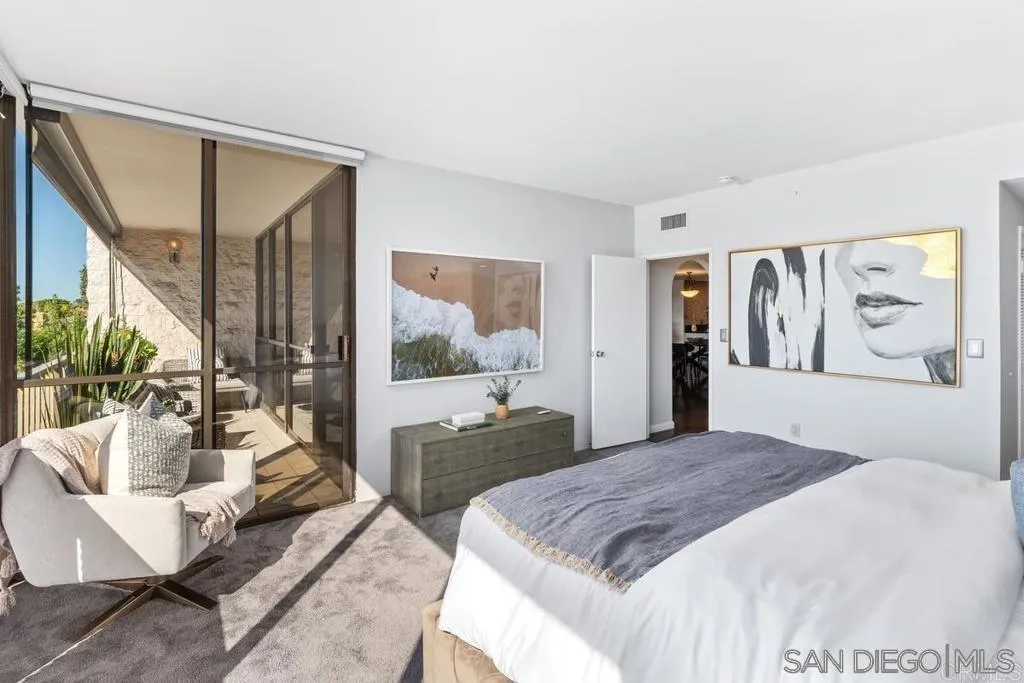 2500 Torrey Pines Road, Unit 402 La Jolla, CA 92037 - Photo 3 of 21 a spacious bedroom with a bed a couch and a large window