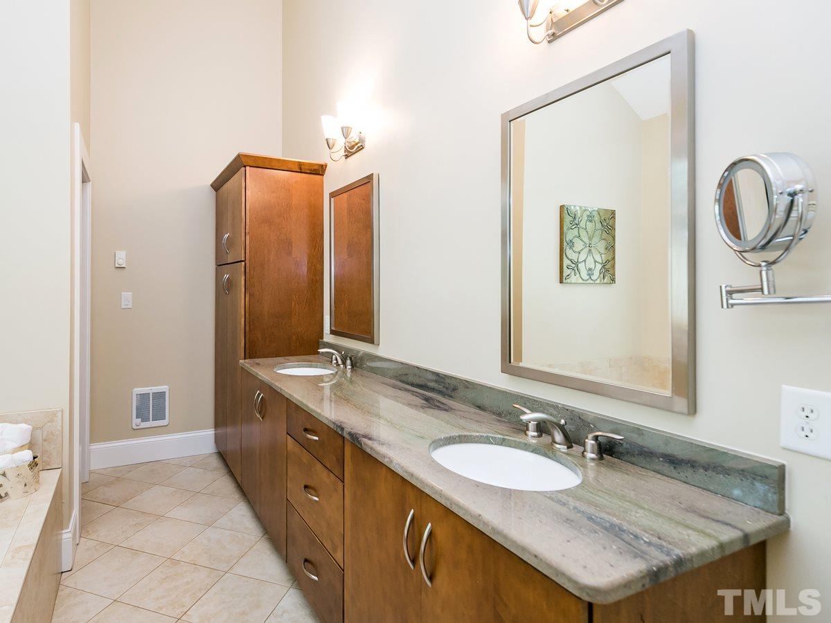 1614 Scales Street Raleigh, NC 27608 - Photo 14 of 25 a spacious bathroom with a granite countertop double vanity and a mirror