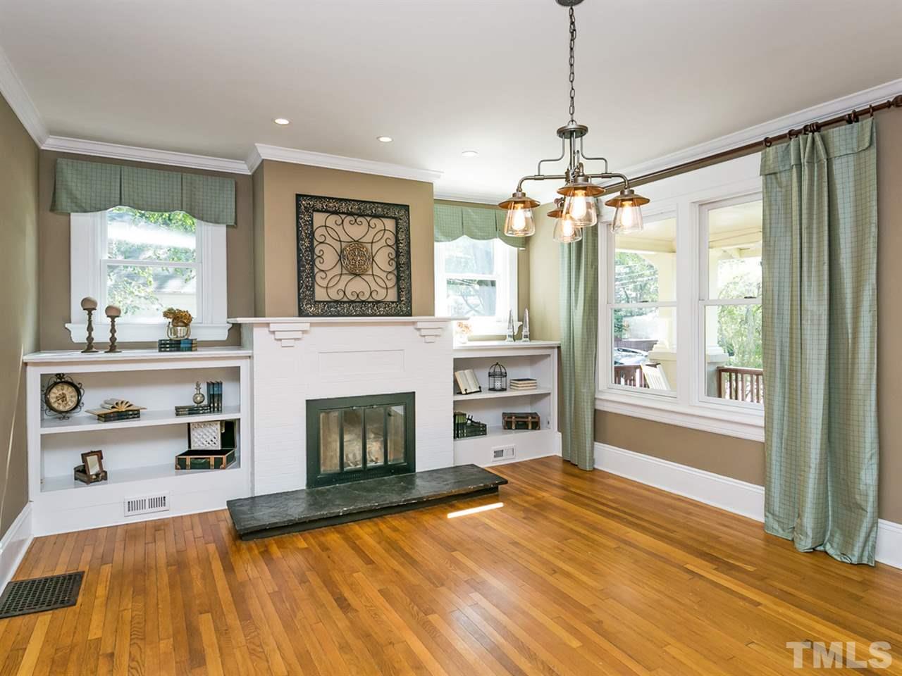 1614 Scales Street Raleigh, NC 27608 - Photo 3 of 25 a view of a livingroom with a window and fireplace