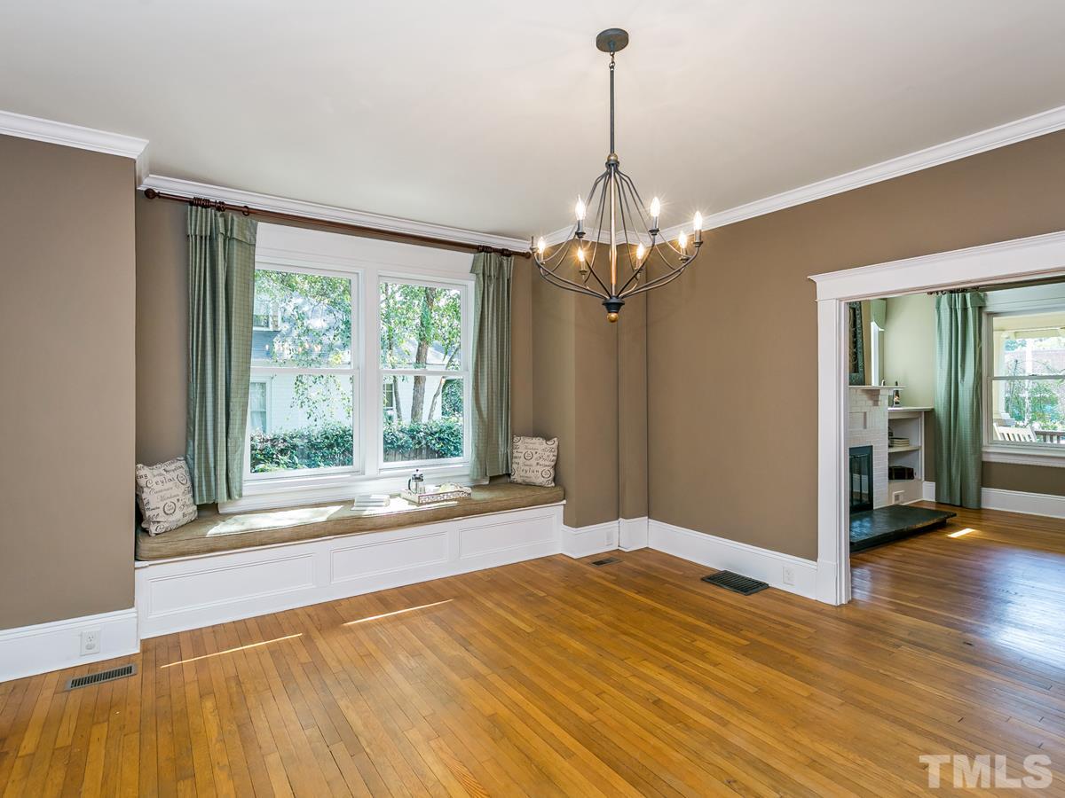1614 Scales Street Raleigh, NC 27608 - Photo 7 of 25 a view of a livingroom with wooden floor a ceiling fan and windows