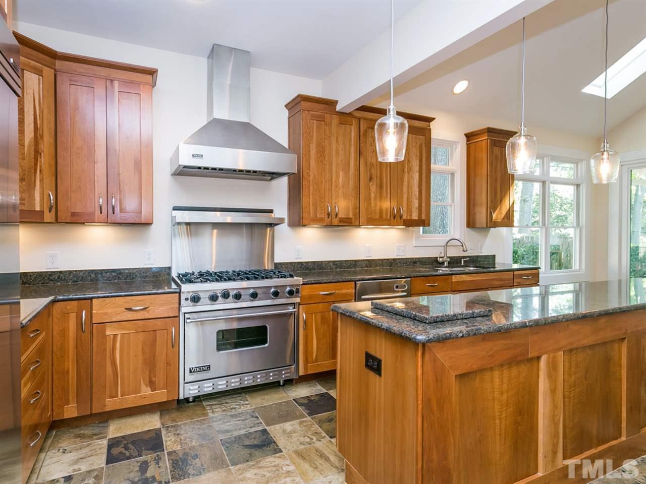 1614 Scales Street Raleigh, NC 27608 - Photo 8 of 25 a kitchen with stainless steel appliances granite countertop a stove a sink and a microwave