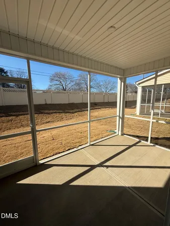 a view of a room with wooden floor and a ceiling fan