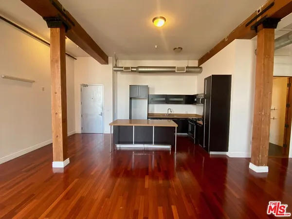 a view of kitchen with cabinets and wooden floor