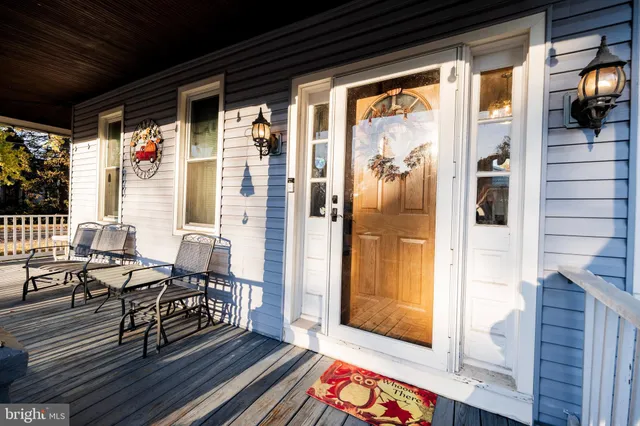 a living room with furniture rug and a window