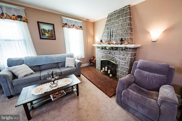 a living room with furniture fireplace and flat screen tv