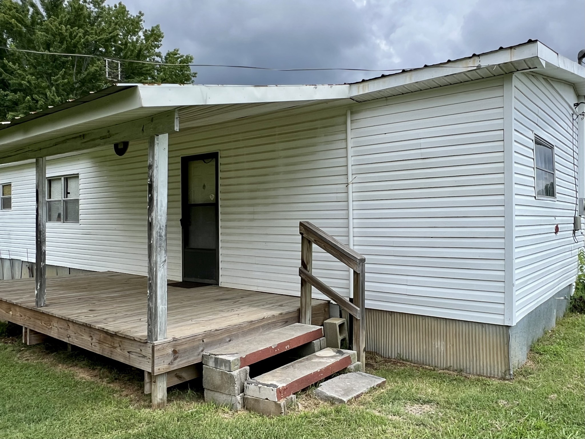 3467 Fall River Road Pulaski, TN 38478 - Photo 25 of 38 a backyard of a house with wooden fence and a large tree