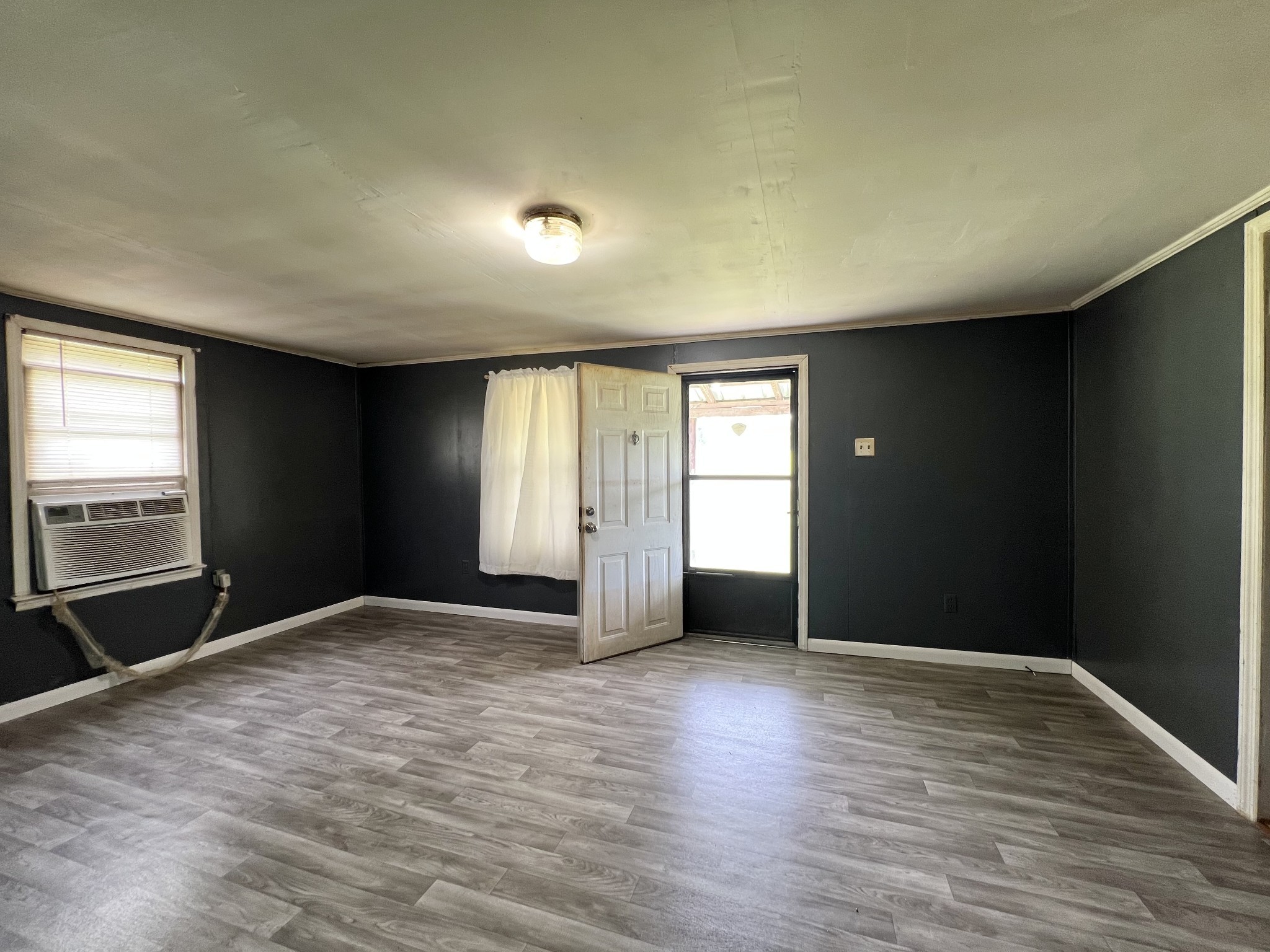 3467 Fall River Road Pulaski, TN 38478 - Photo 26 of 38 an empty room with wooden floor and windows