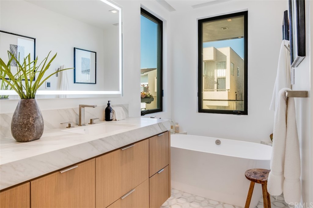 200 40th Street Manhattan Beach, CA 90266 - Photo 33 of 57 a bathroom with a granite countertop sink a mirror and a bathtub
