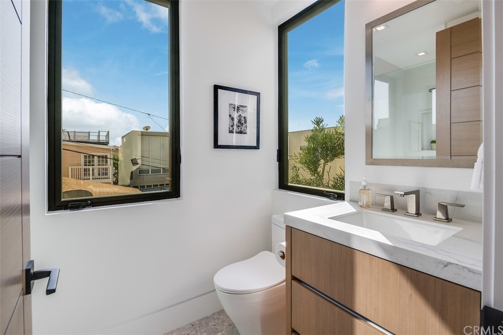 200 40th Street Manhattan Beach, CA 90266 - Photo 43 of 57 a bathroom with a toilet sink and mirror