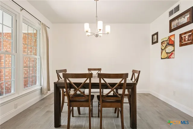 a kitchen with stainless steel appliances granite countertop a sink a stove and cabinets