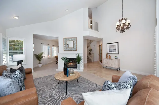 a living room with furniture chandelier and a table