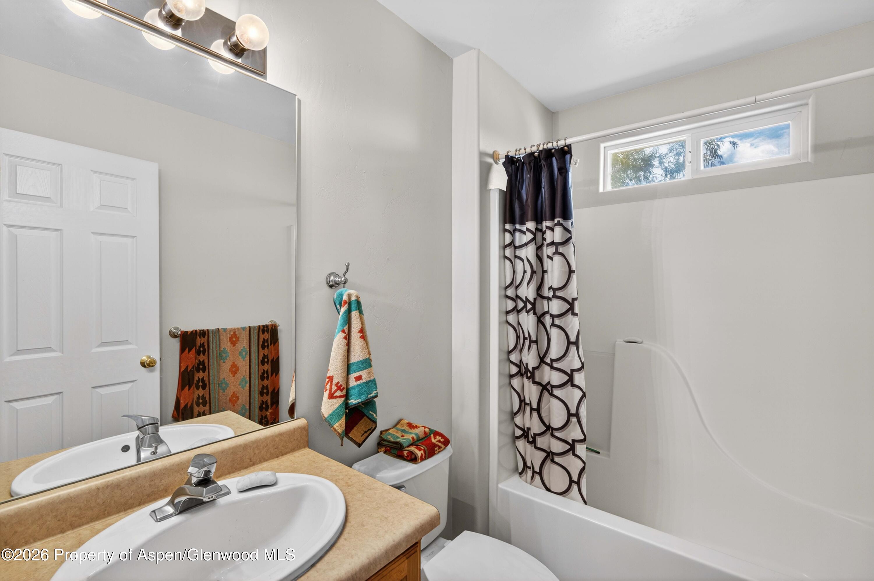 608 Lariat Loop New Castle, CO 81647 - Photo 23 of 32 a bathroom with a sink and a mirror