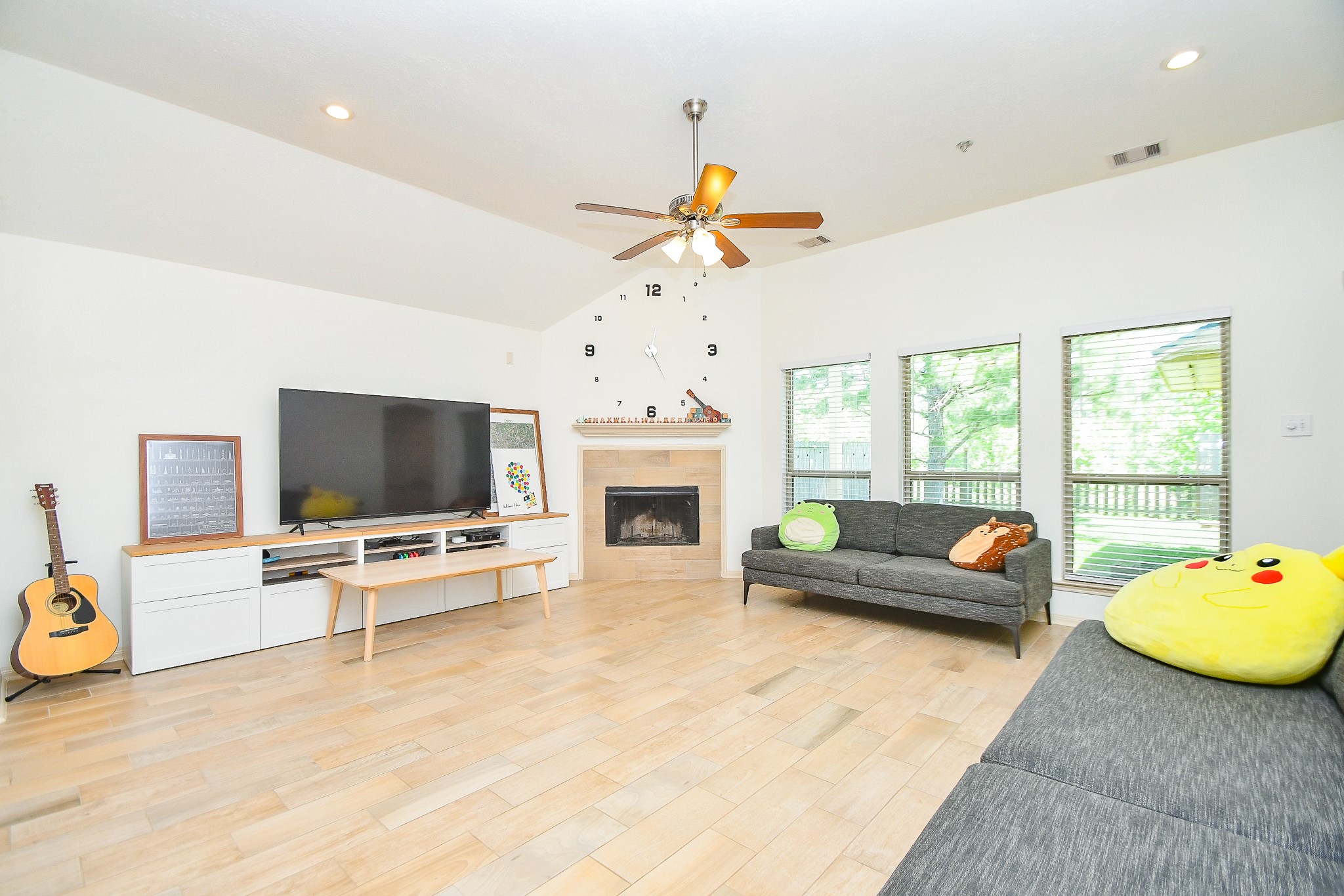 16814 Ranger Ridge Drive Cypress, TX 77429 - Photo 3 of 42 Open-concept family room with high ceilings, built-in entertainment niche, and tile flooring throughout.