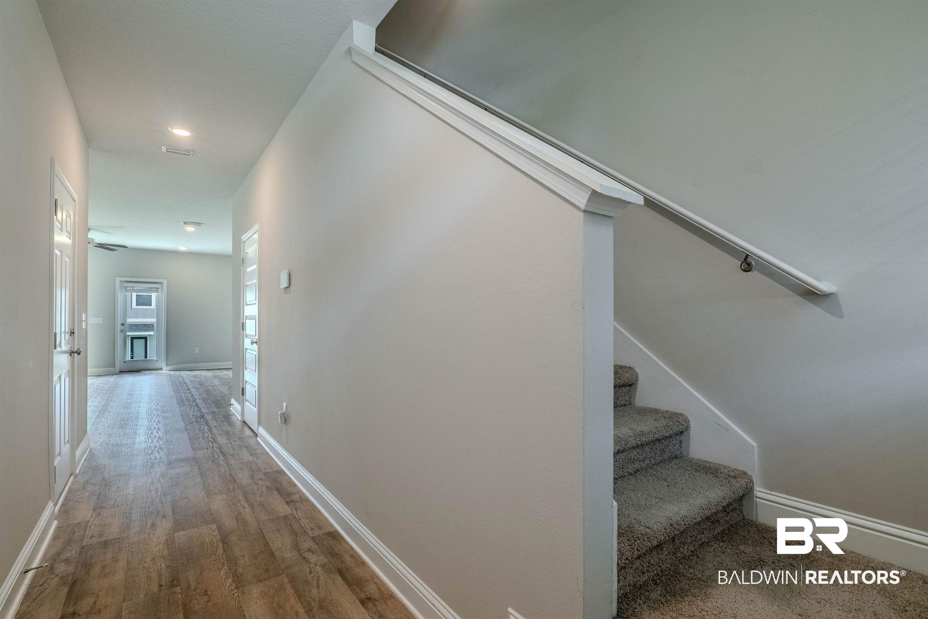 25806 Pollard Road, Unit 32 Daphne, AL 36526 - Photo 10 of 23 Hallway featuring wood-type flooring