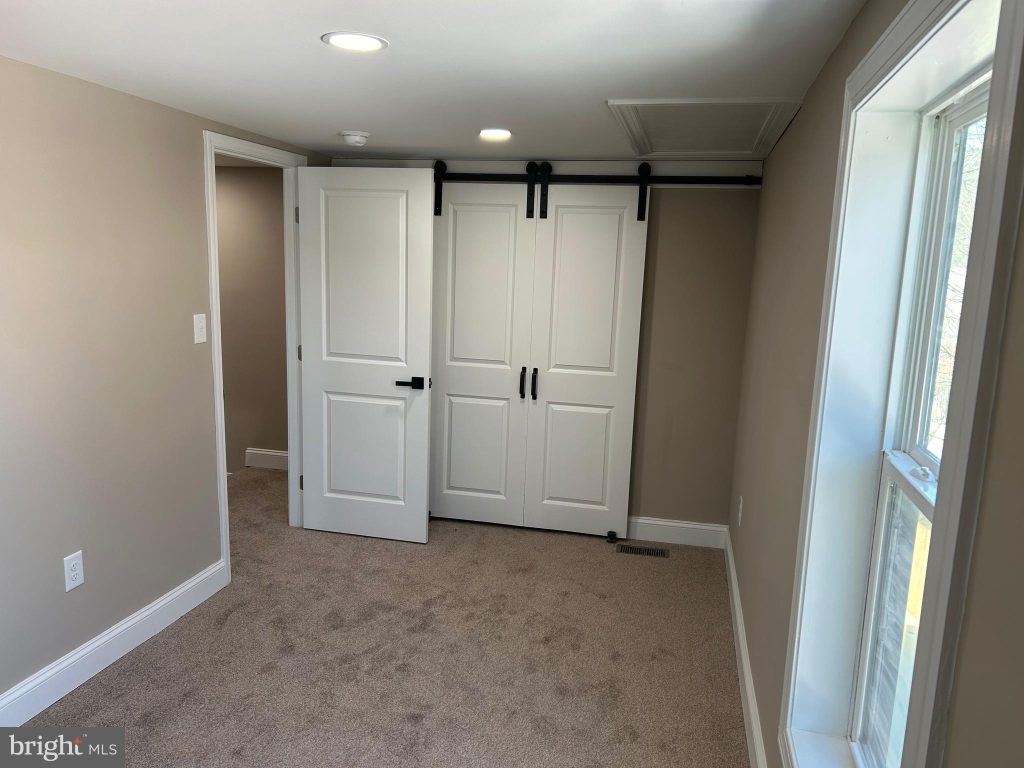 10763 Path Valley Road Fannettsburg, PA 17221 - Photo 20 of 35 an empty room with wooden cabinet and door
