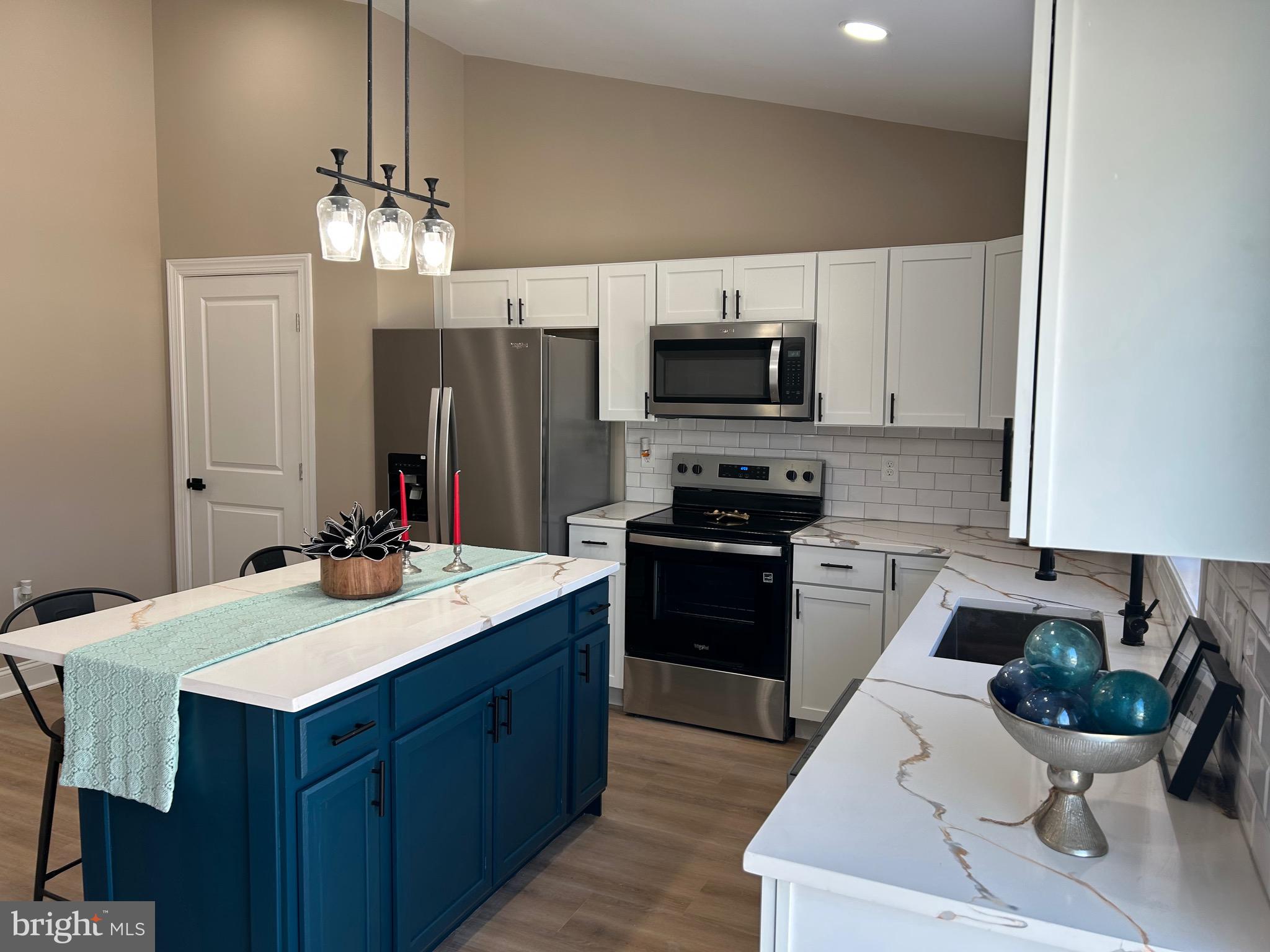 10763 Path Valley Road Fannettsburg, PA 17221 - Photo 5 of 35 a kitchen with a sink stove and microwave