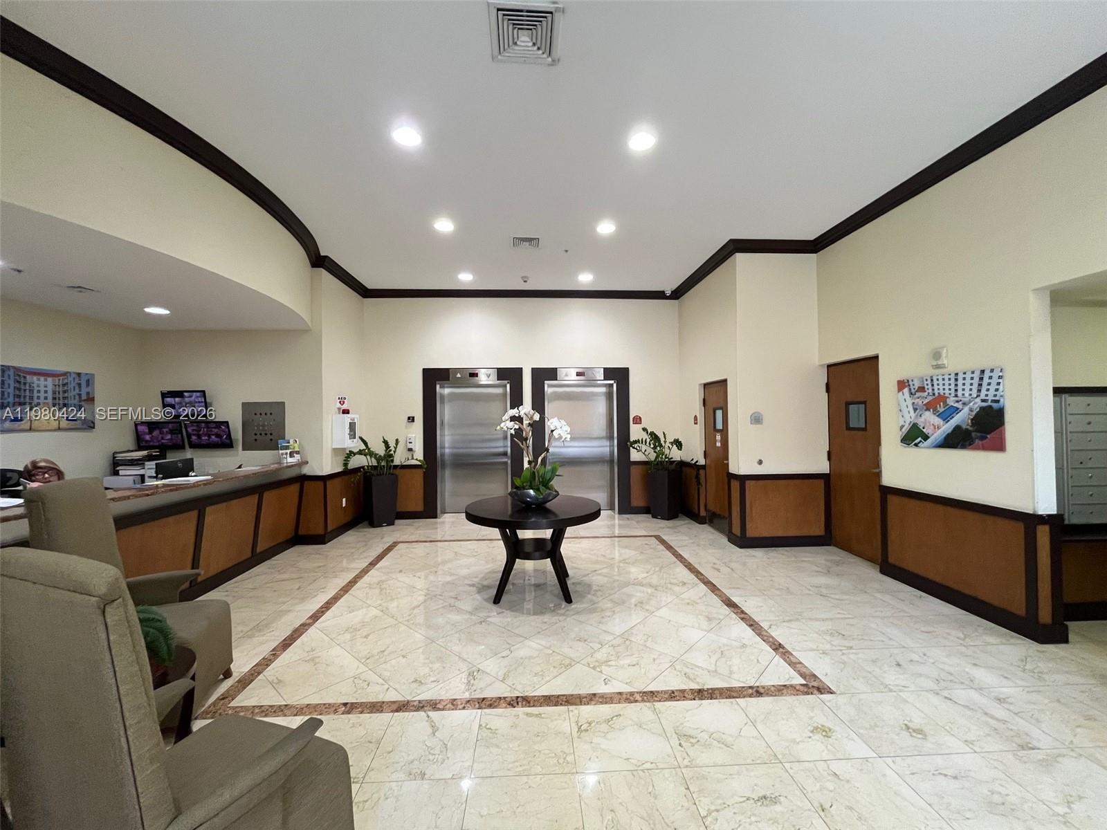 2030 Douglas Road, Unit 610 Coral Gables, FL 33134 - Photo 11 of 19 a living room with furniture gym equipment and a table