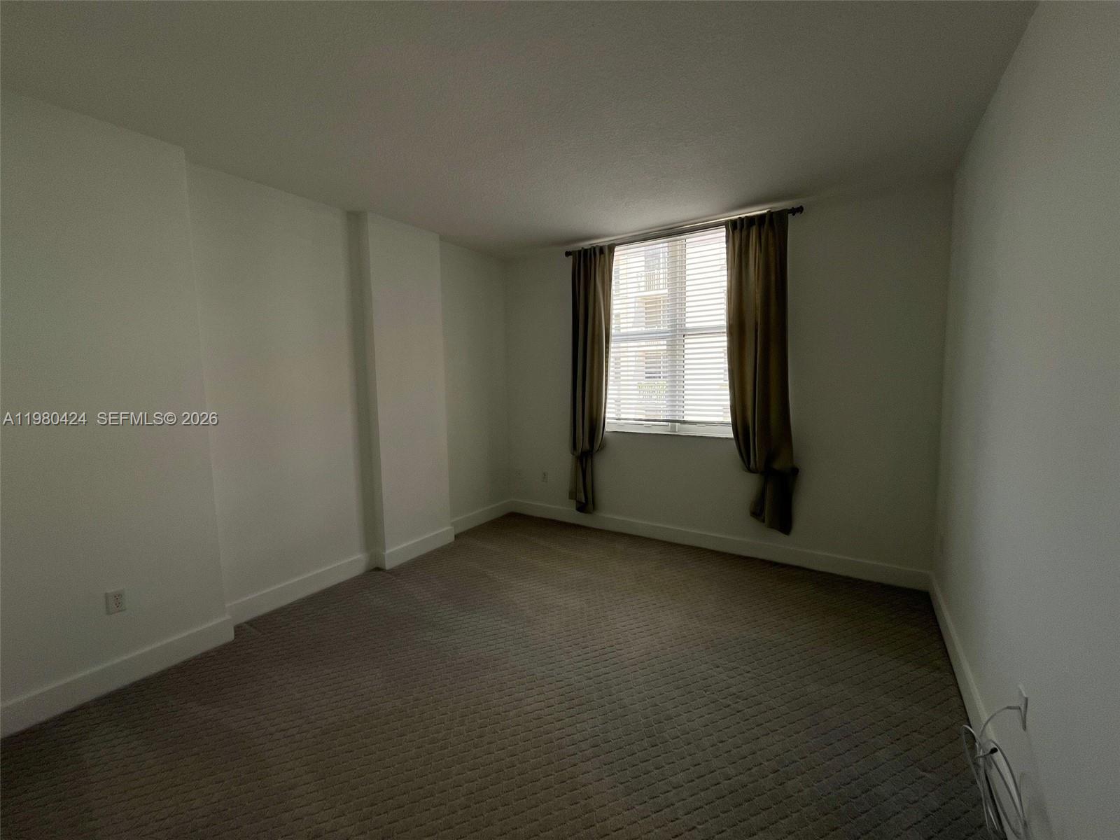 2030 Douglas Road, Unit 610 Coral Gables, FL 33134 - Photo 12 of 19 an empty room with a window
