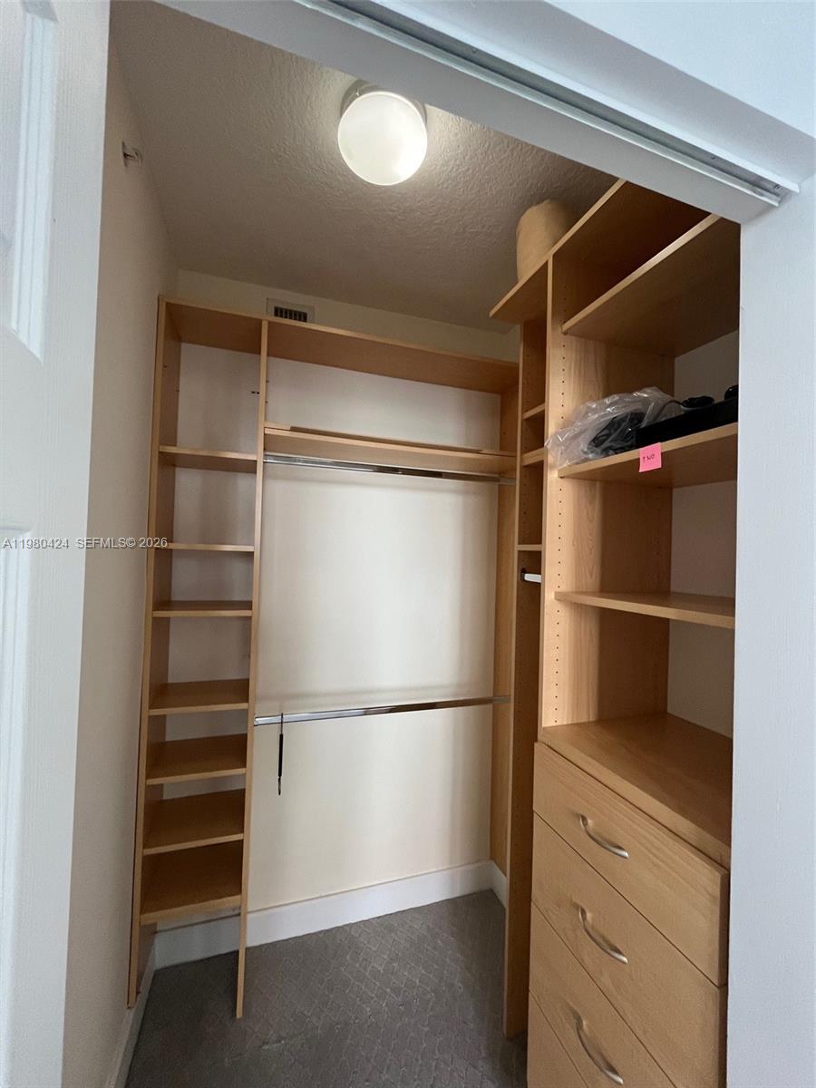 2030 Douglas Road, Unit 610 Coral Gables, FL 33134 - Photo 13 of 19 a view of walk in closet with empty racks