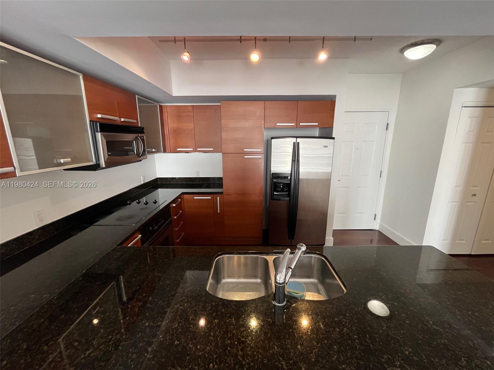 2030 Douglas Road, Unit 610 Coral Gables, FL 33134 - Photo 3 of 19 a kitchen with a sink and stainless steel appliances