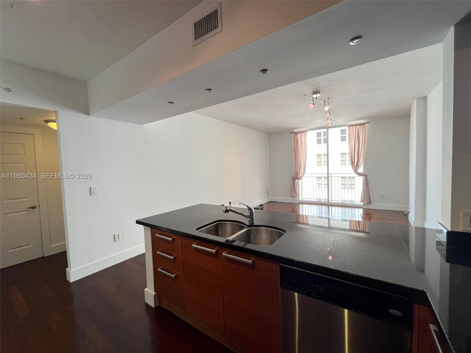 2030 Douglas Road, Unit 610 Coral Gables, FL 33134 - Photo 5 of 19 a kitchen that has a sink and a stove