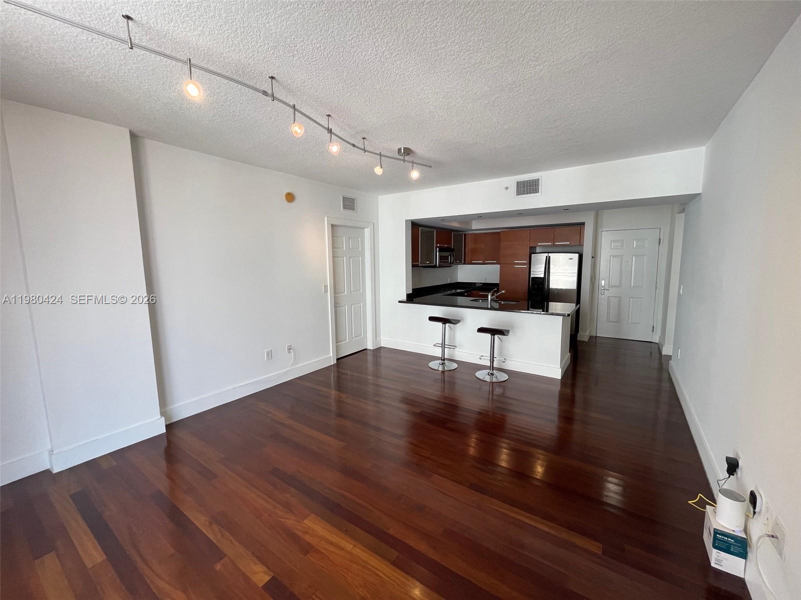 2030 Douglas Road, Unit 610 Coral Gables, FL 33134 - Photo 6 of 19 a view of kitchen with microwave and furniture