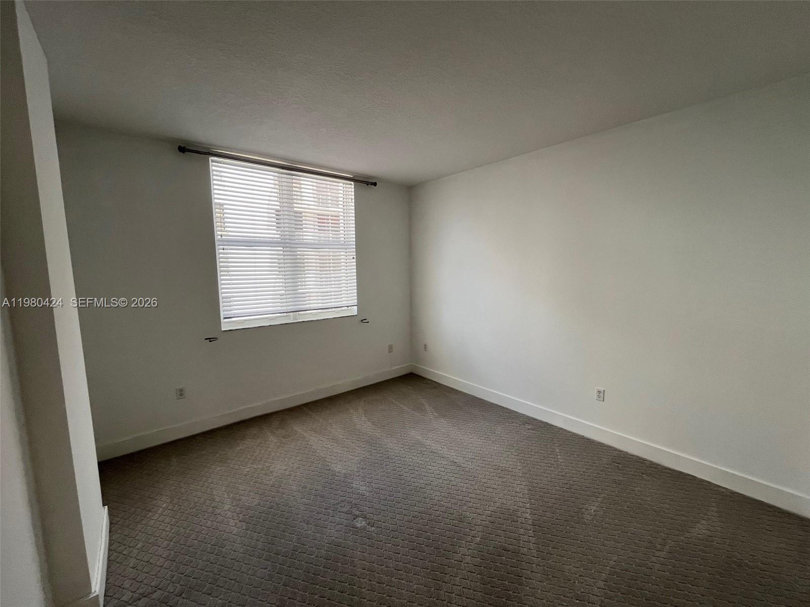 2030 Douglas Road, Unit 610 Coral Gables, FL 33134 - Photo 7 of 19 an empty room with a window