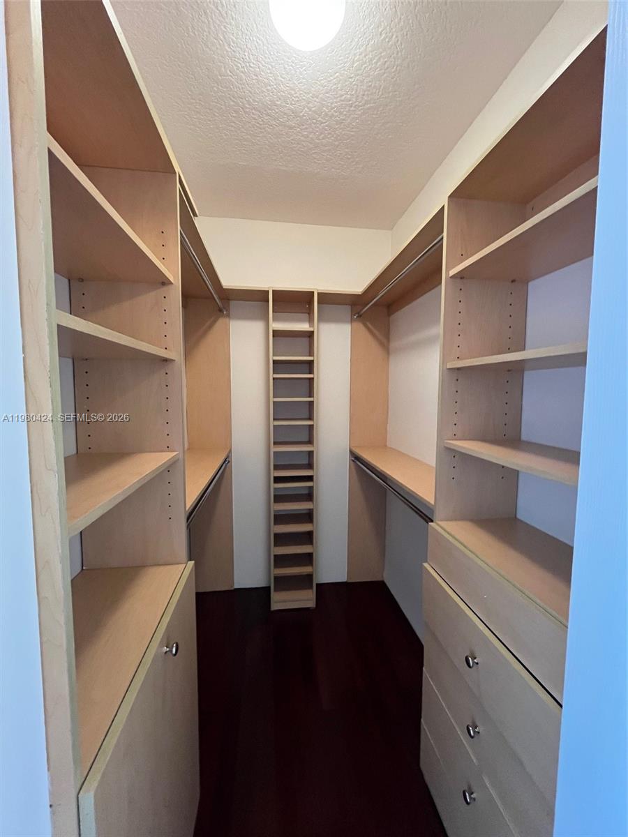 2030 Douglas Road, Unit 610 Coral Gables, FL 33134 - Photo 8 of 19 a view of walk in closet with empty racks