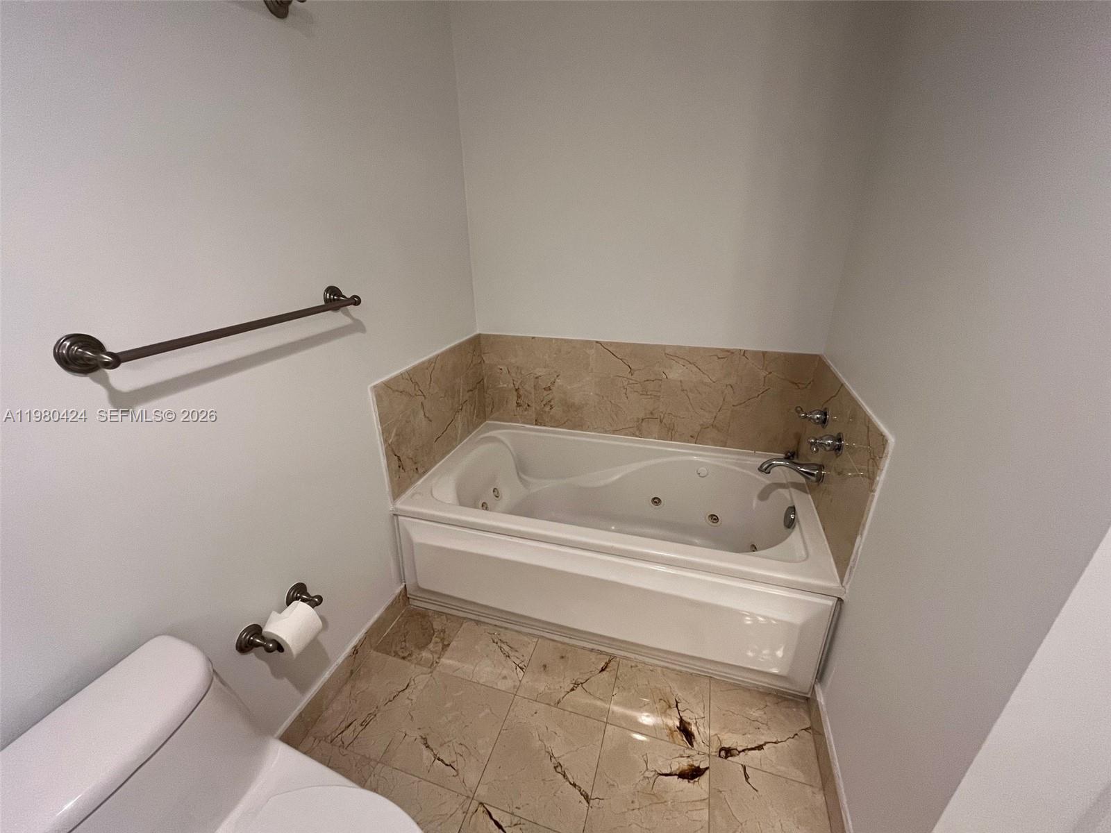 2030 Douglas Road, Unit 610 Coral Gables, FL 33134 - Photo 10 of 19 a bathroom with a bathtub and toilet