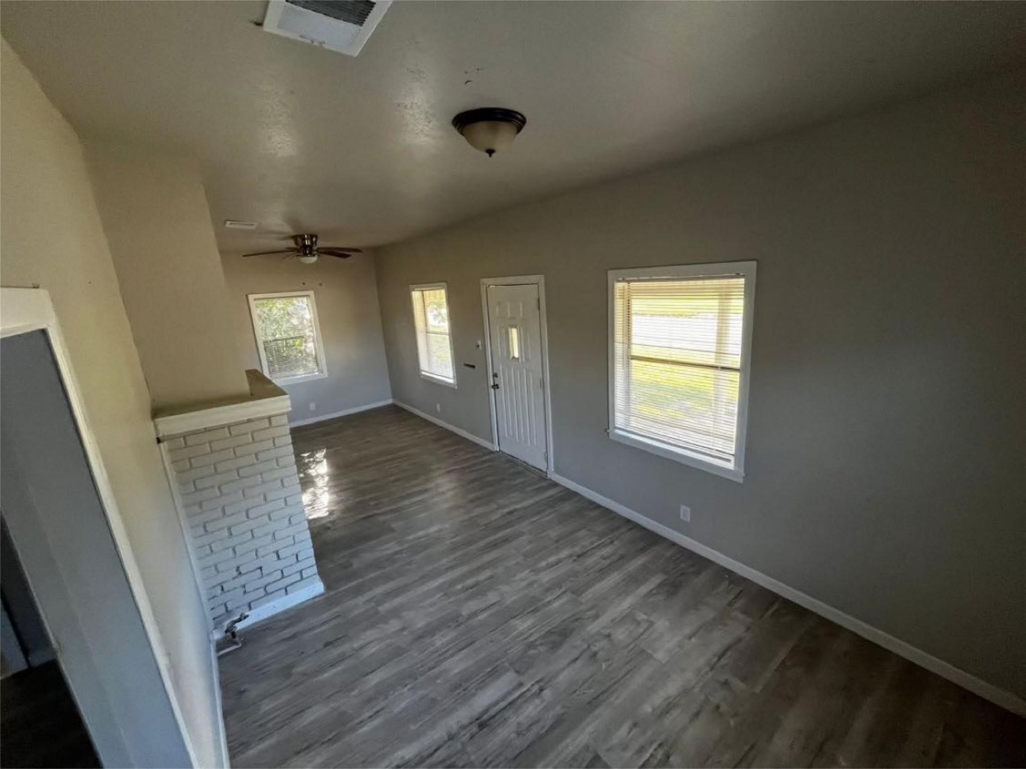 1648 West Rev Dr Ransom Howard Street Port Arthur, TX 77640 - Photo 9 of 12 a view of an empty room with wooden floor and a window