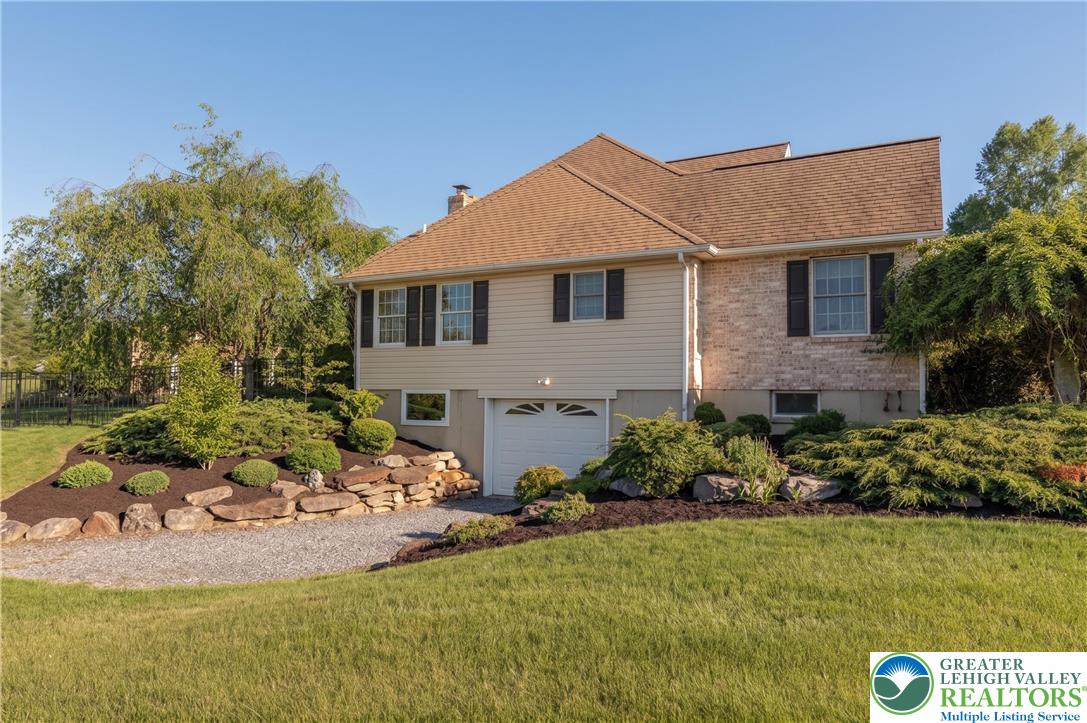1089 Deemer Road Bath, PA 18014 - Photo 7 of 57 This charming residence features a well-maintained exterior and a neatly landscaped yard.