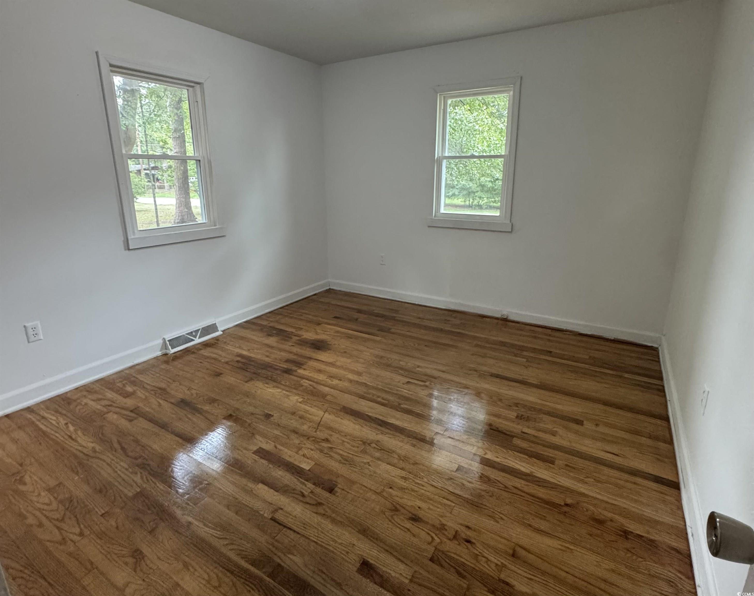 1127 State Rd S-17-640 Dillon, SC 29536 - Photo 19 of 26 Empty room with wood finished floors and baseboards