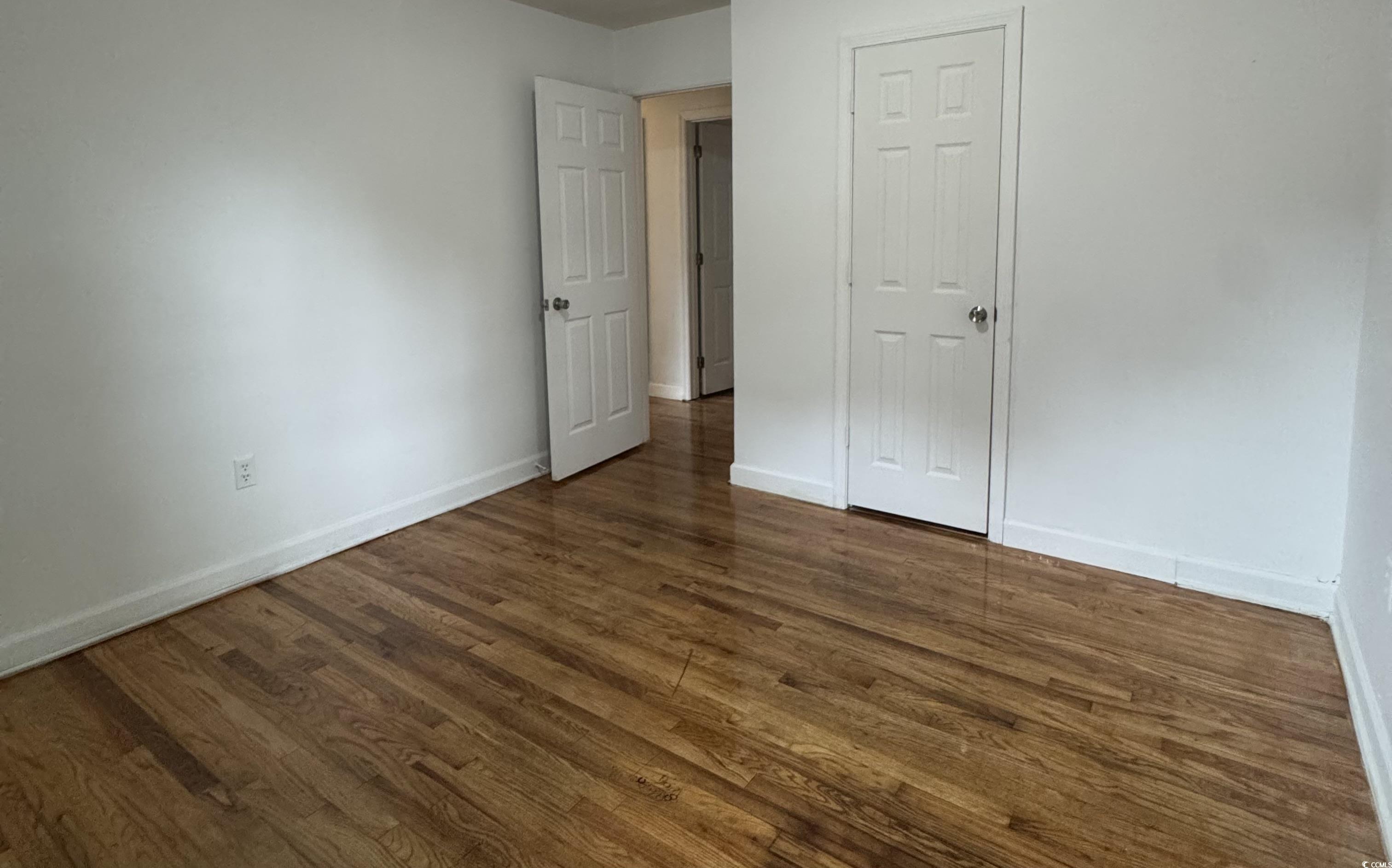 1127 State Rd S-17-640 Dillon, SC 29536 - Photo 21 of 26 Unfurnished bedroom with dark wood-style flooring and baseboards