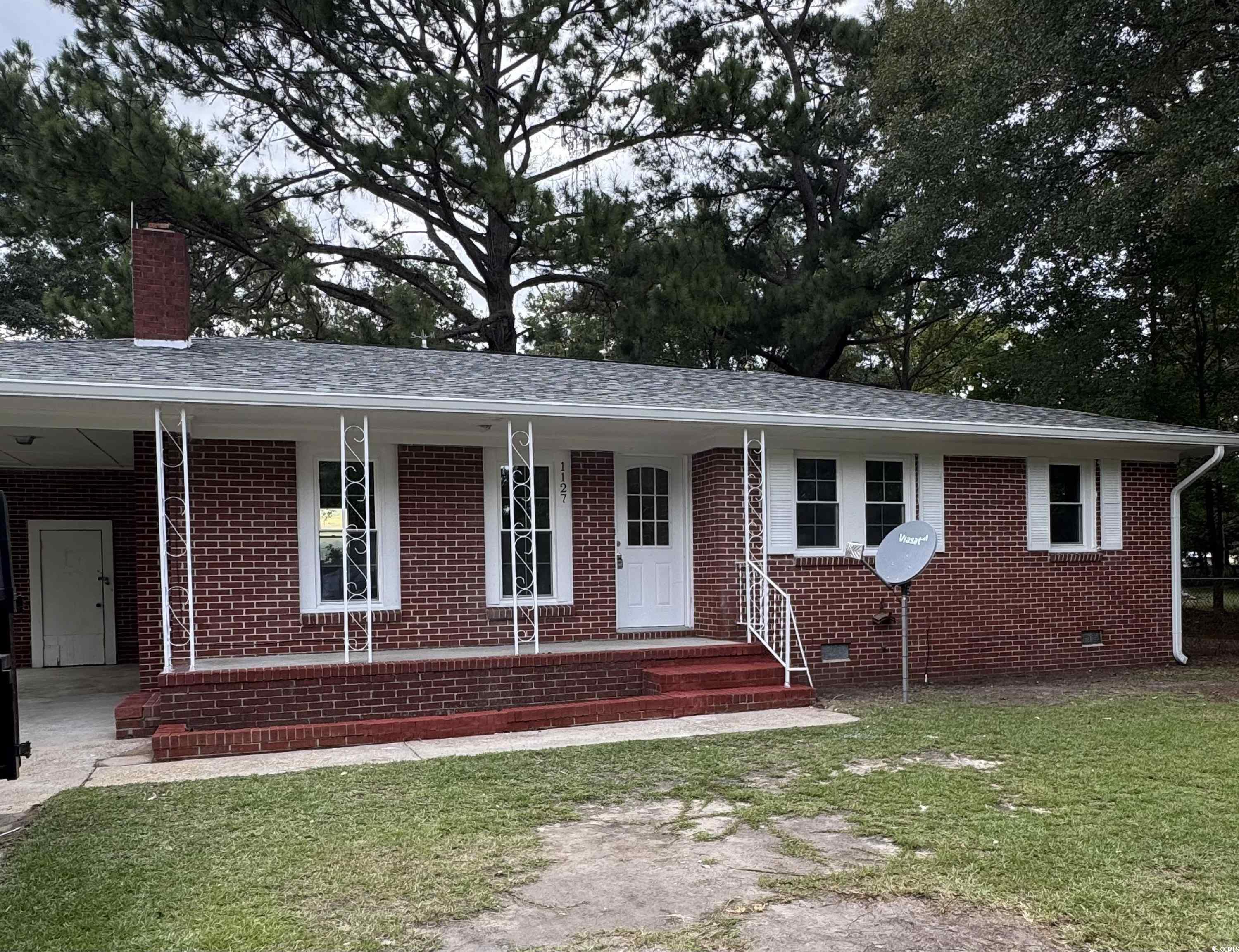 1127 State Rd S-17-640 Dillon, SC 29536 - Photo 3 of 26 Single story home featuring a porch, a front lawn, crawl space, and a chimney
