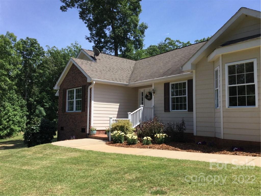 134 V S Dalton Road Rutherfordton, NC 28139 - Photo 14 of 43 a front view of a house with a yard and garage
